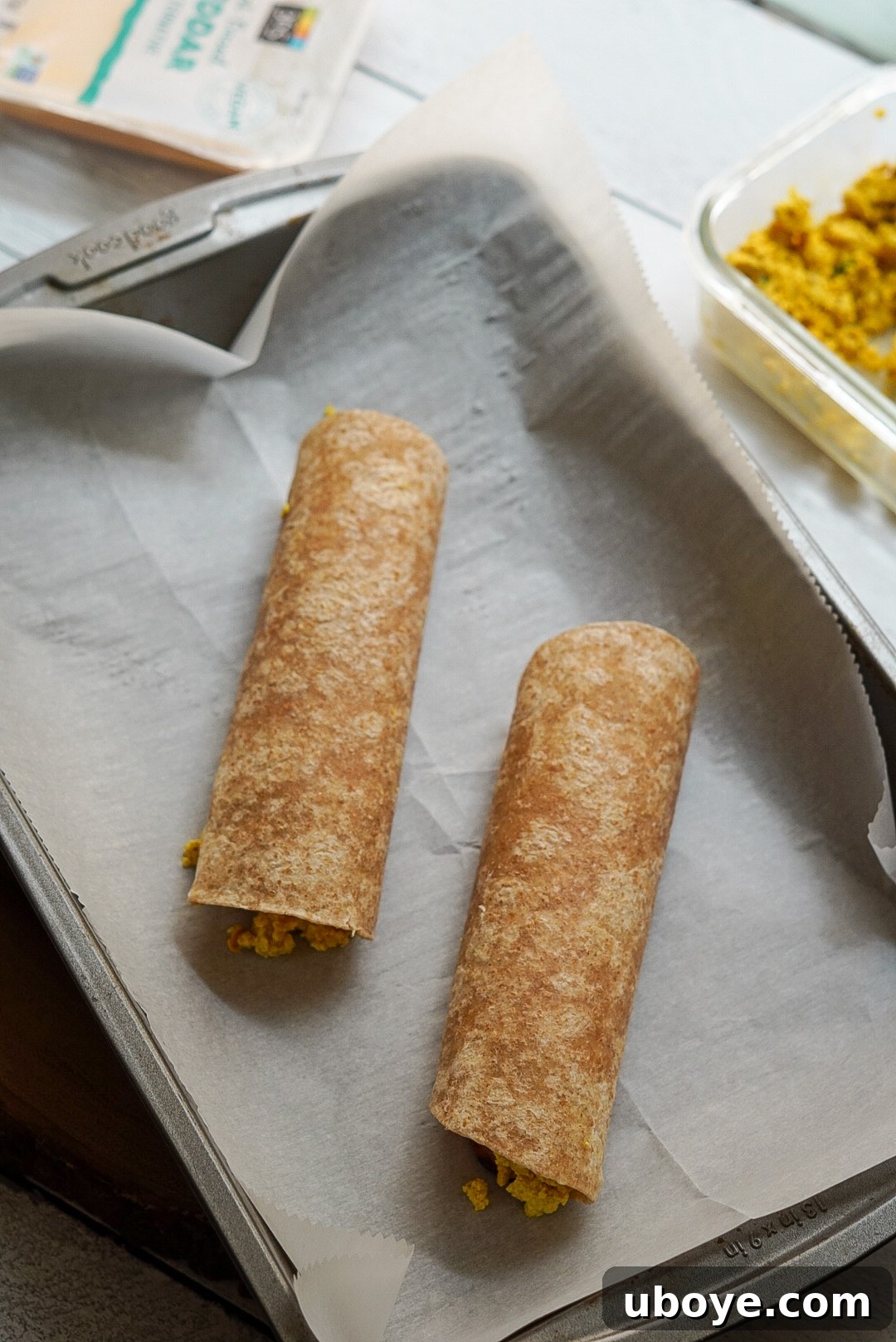 Golden Bacon Cheddar Breakfast Bites 7 Baked vegan breakfast taquitos arranged on a plate