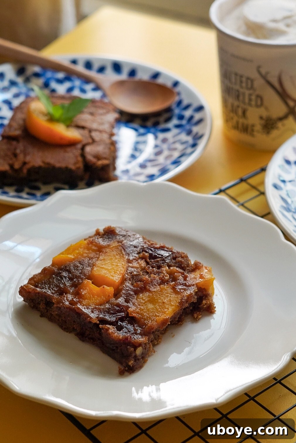 Close-up of the delicious Brown Sugar Peach Spoon Cake in a baking dish, showcasing its gooey texture.