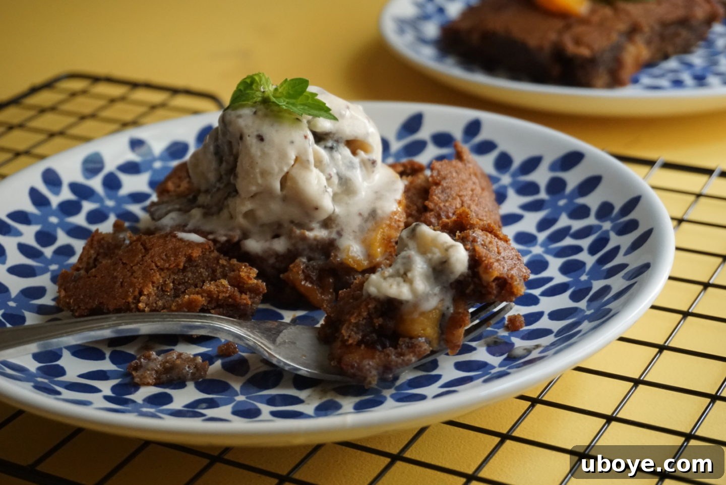A freshly baked Brown Sugar Peach Spoon Cake cooling on a rack, steam rising.