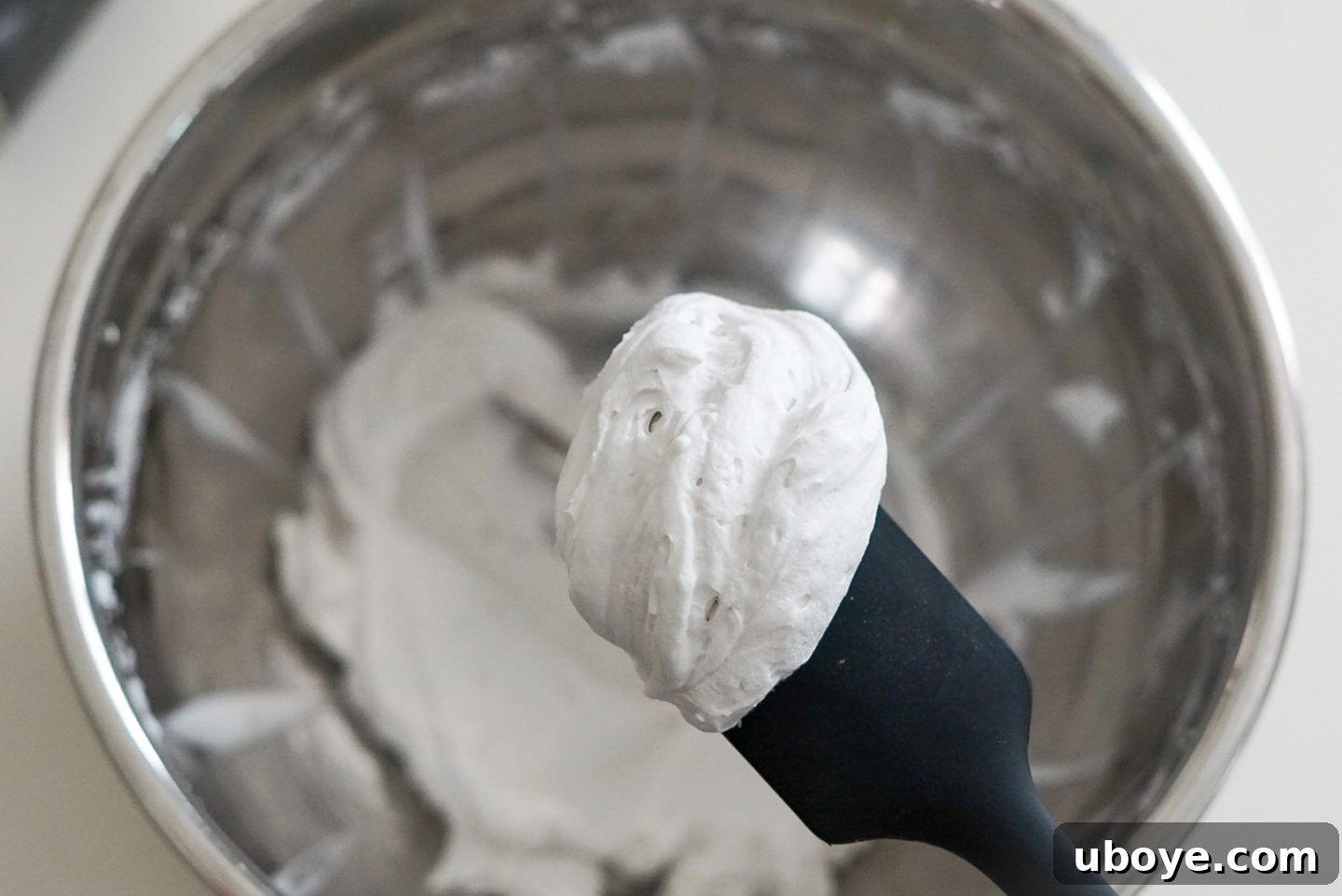 A close-up shot of perfectly whipped coconut cream, showcasing its light, airy texture and inviting appearance.