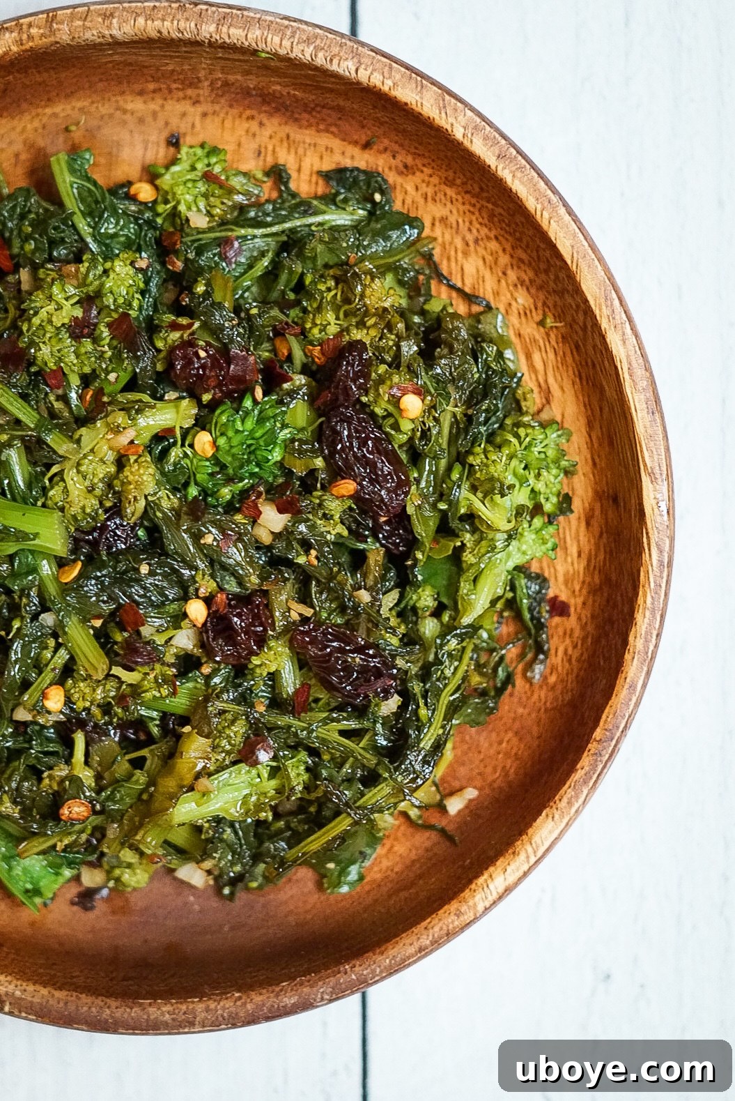 Ingredients for Balsamic Broccoli Rabe laid out, including fresh broccoli rabe, olive oil, spices, and balsamic vinegar.