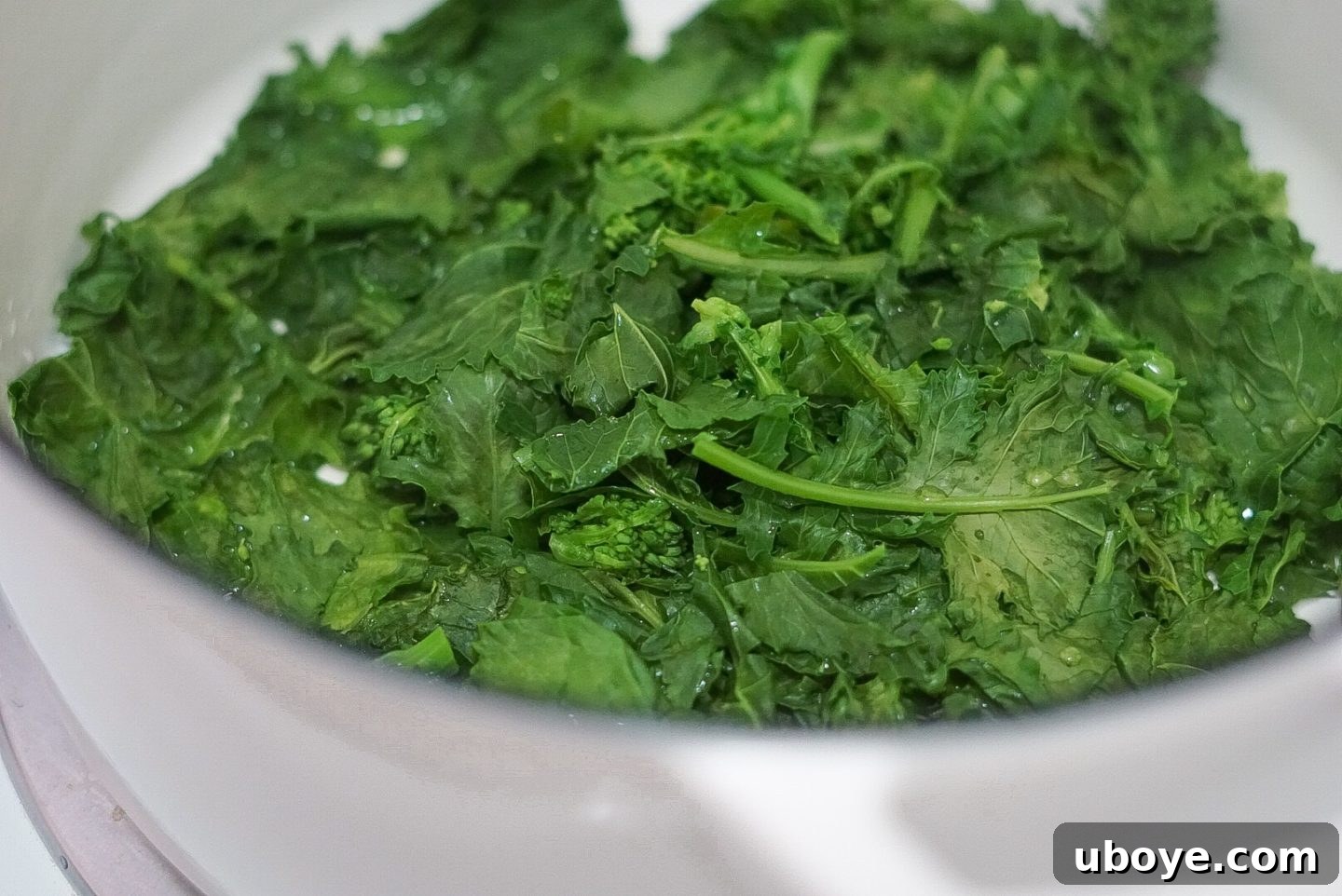 Broccoli Rabe steaming in a pan with water and salt.