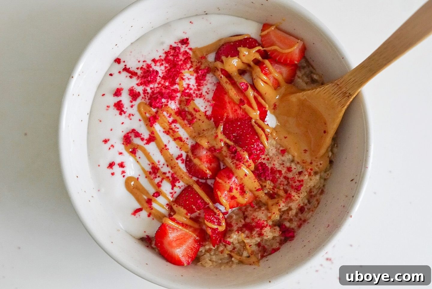 Rainbow Quick Oats 3 Close-up of creamy oatmeal generously topped with fresh berries, nuts, and raspberry sprinkles