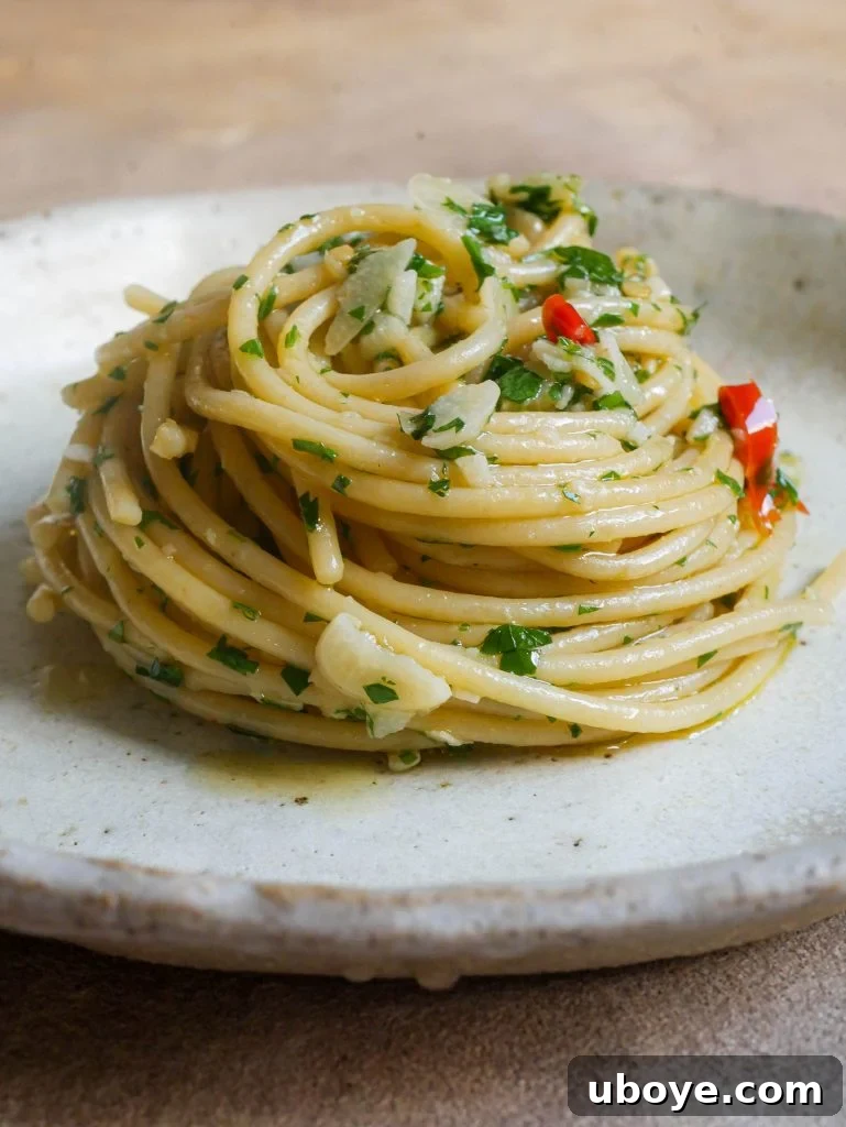 Classic Garlic and Olive Oil 2 A beautifully plated dish of Aglio e Olio pasta garnished with fresh parsley and chili flakes.