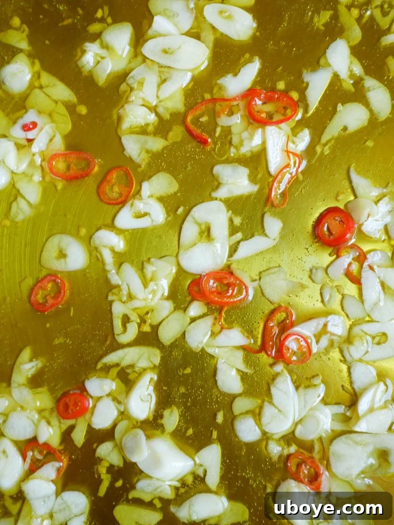 Classic Garlic and Olive Oil 4 A close-up shot of the finished Aglio e Olio pasta, generously garnished with fresh parsley.
