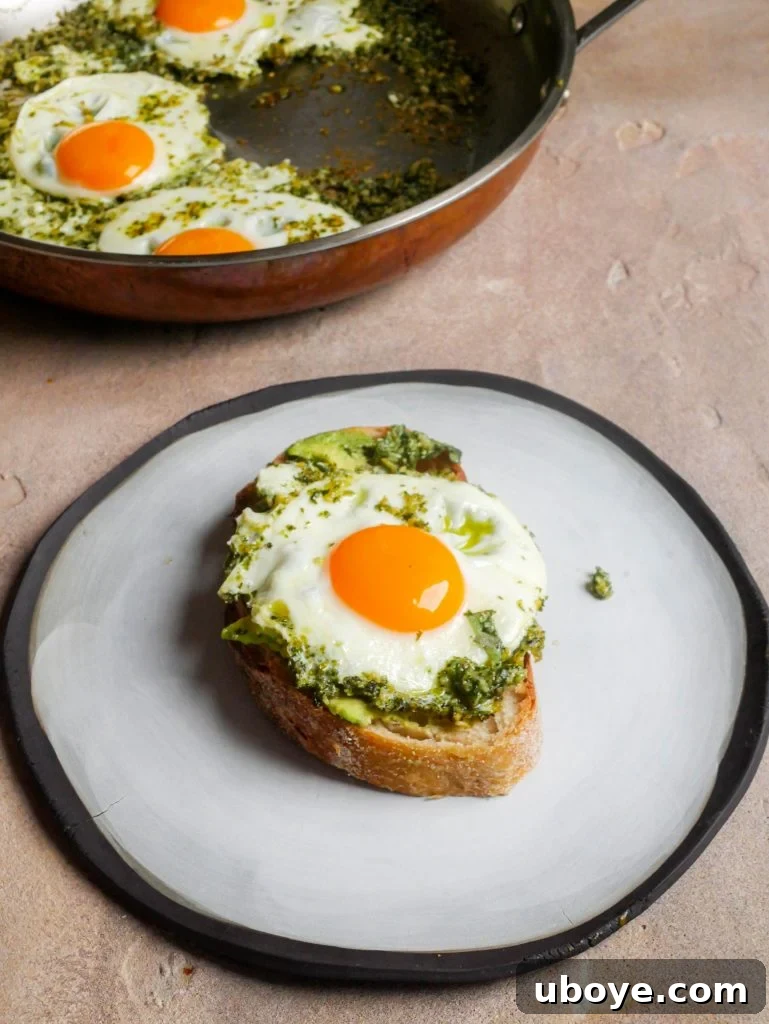Pesto-Kissed Eggs 4 Close-up of crispy-edged pesto eggs served on a wooden board