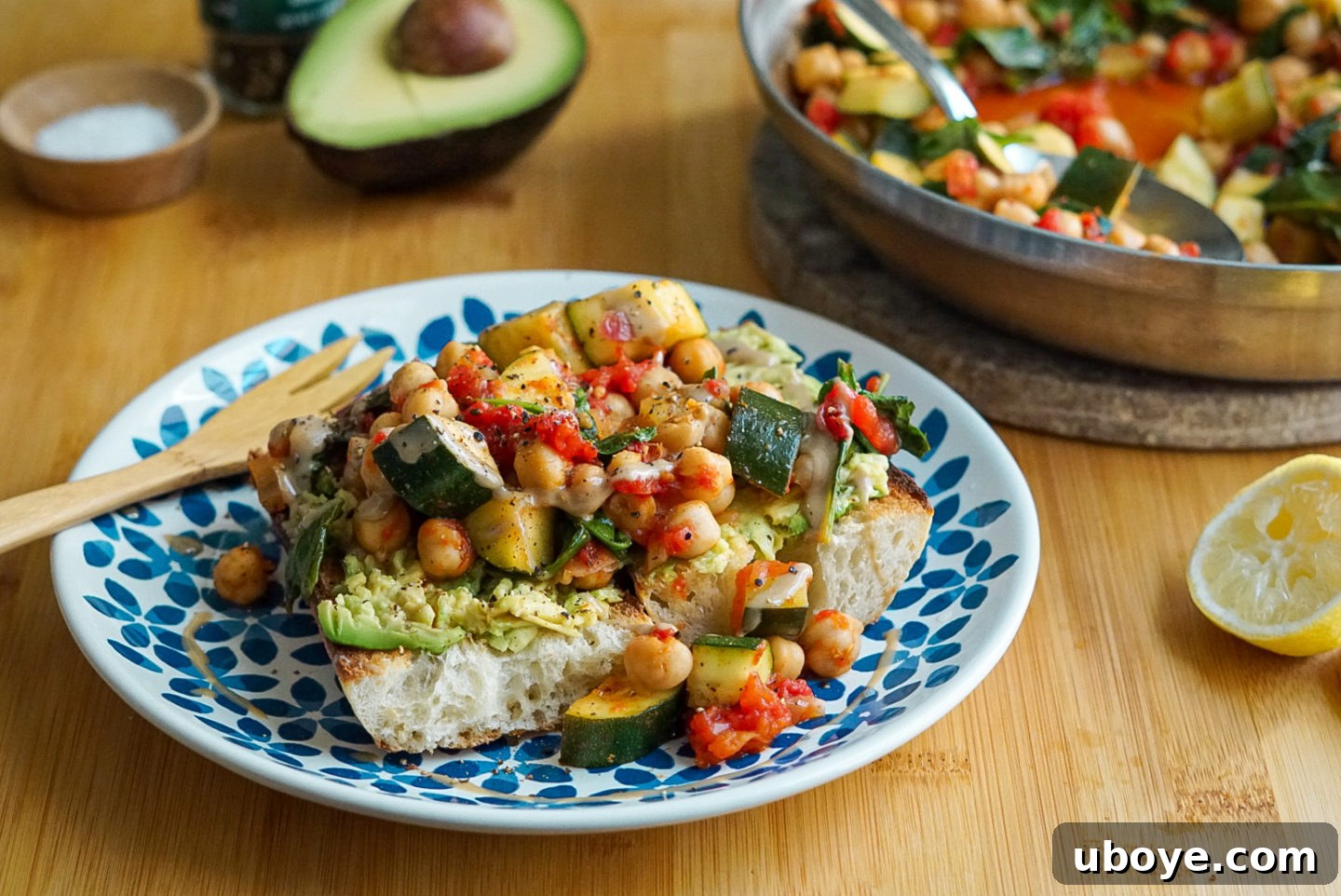 A serving of Italian Zucchini and Chickpea Skillet on toasted bread, garnished with fresh basil.
