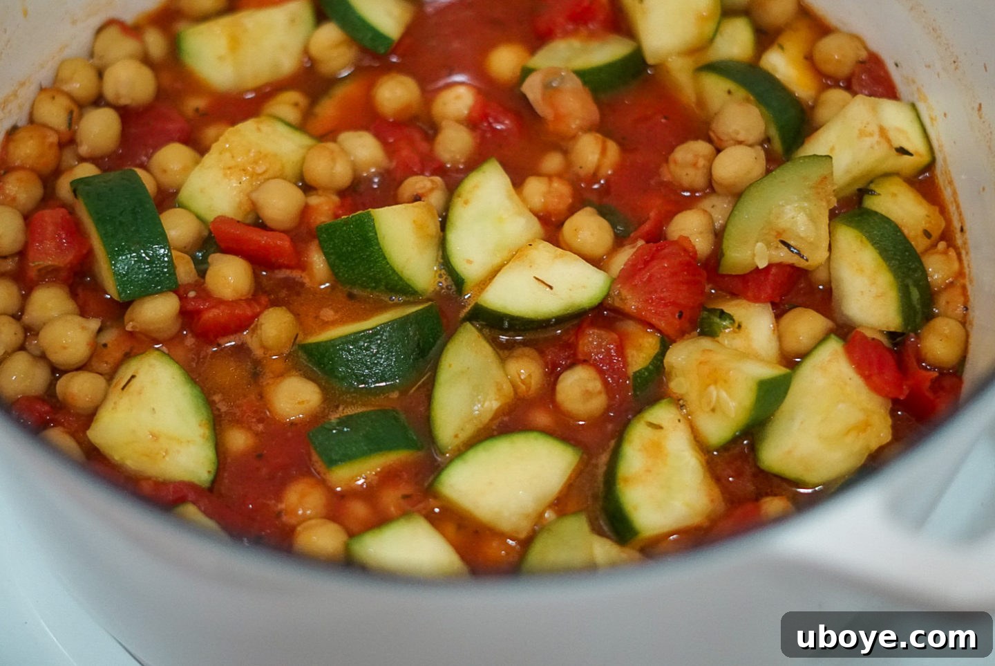 A close-up shot of the finished Italian Zucchini and Chickpea Skillet, featuring herbs and a rustic background.