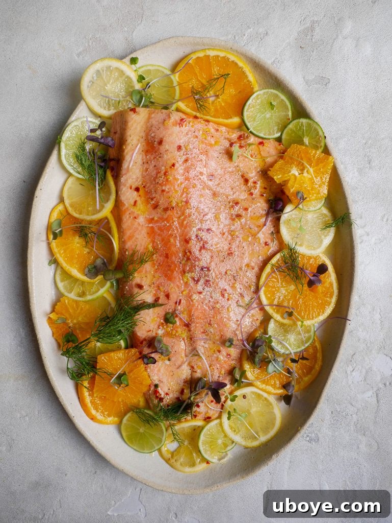 Close-up of fresh salmon fillets ready for roasting with citrus slices.