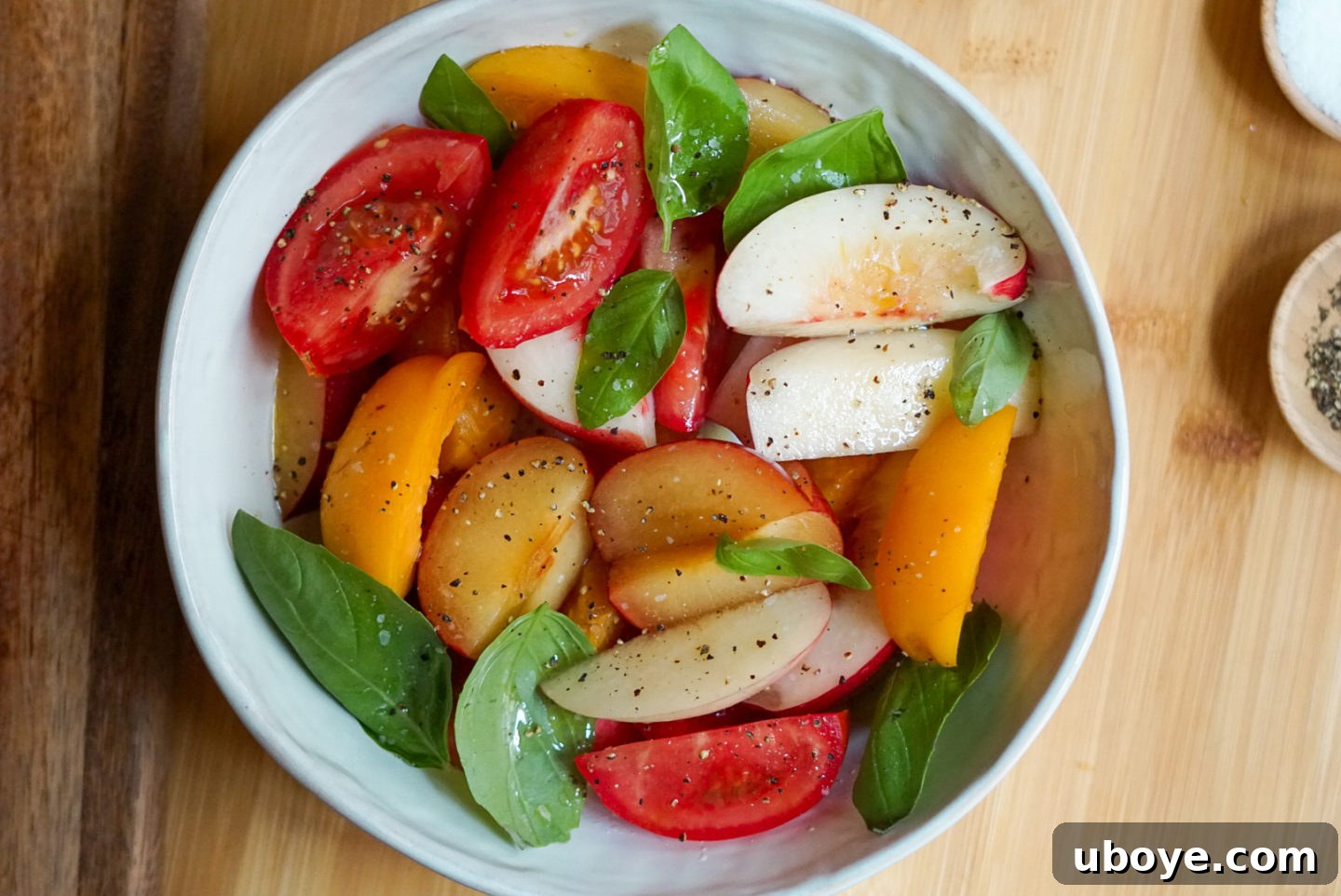 Sweet & Savory Stone Fruit, Tomato, and Basil Medley 2 A vibrant bowl of Stone Fruit and Tomato Basil Salad with peaches, nectarines, plums, and tomatoes