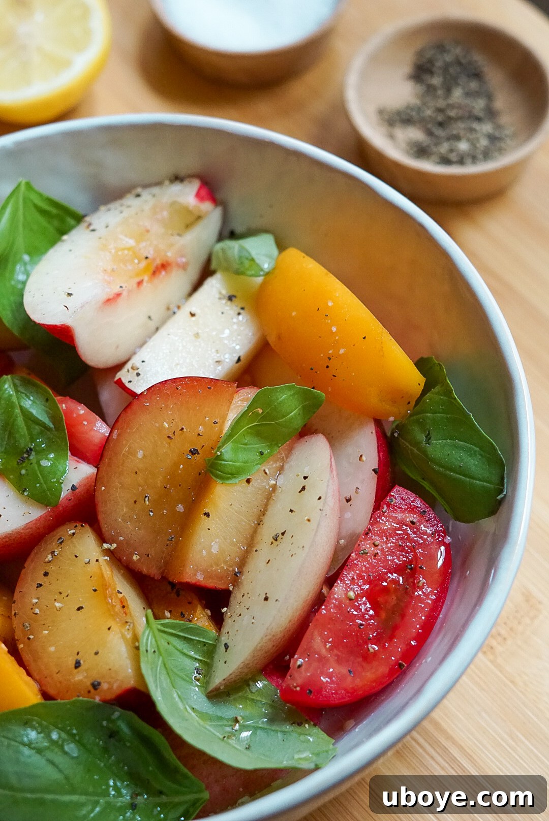 Sweet & Savory Stone Fruit, Tomato, and Basil Medley 3 Close-up of Stone Fruit and Tomato Basil Salad in a cream-colored bowl