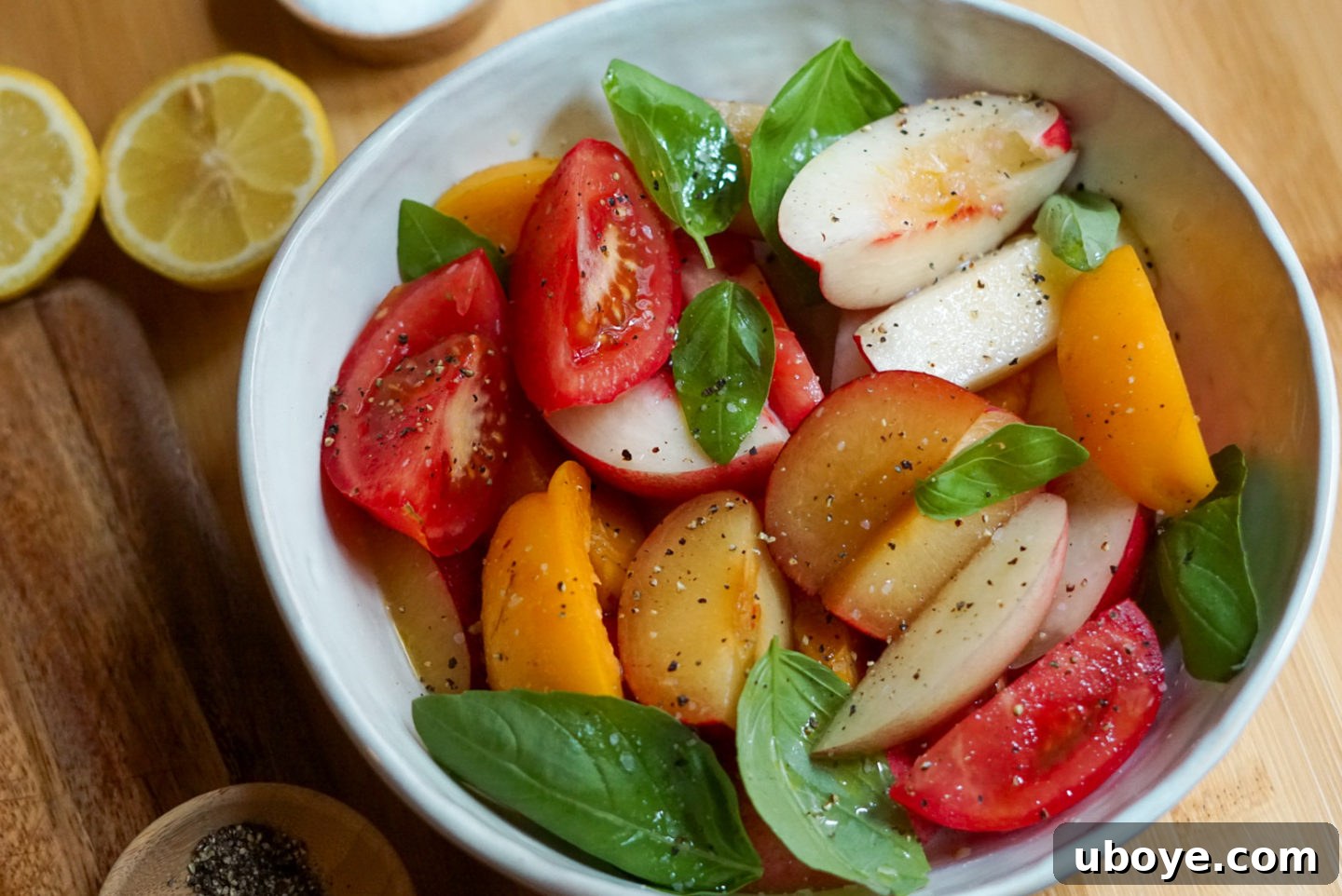 Sweet & Savory Stone Fruit, Tomato, and Basil Medley 5 Fresh basil leaves scattered over the colorful Stone Fruit and Tomato Basil Salad