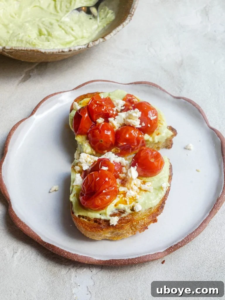 Freshly made whipped avocado and cream cheese spread on a wooden board