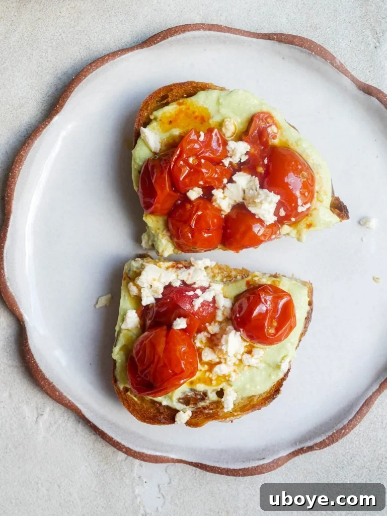 Whipped avocado and cream cheese spread garnished with fresh herbs and olive oil