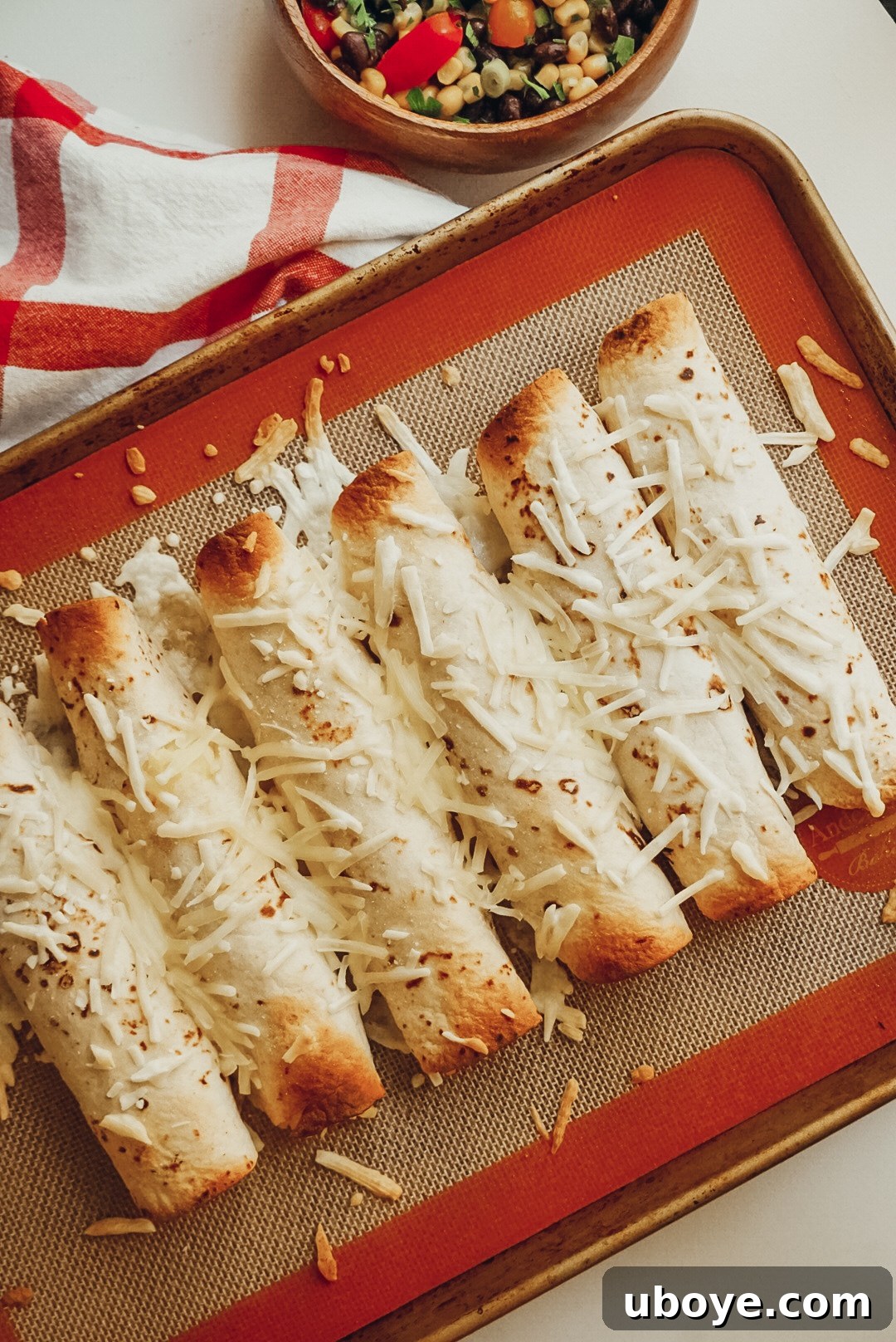 Golden Oven-Baked Potato Taquitos 2 Crispy baked vegan potato taquitos garnished with fresh cilantro, ready to be served