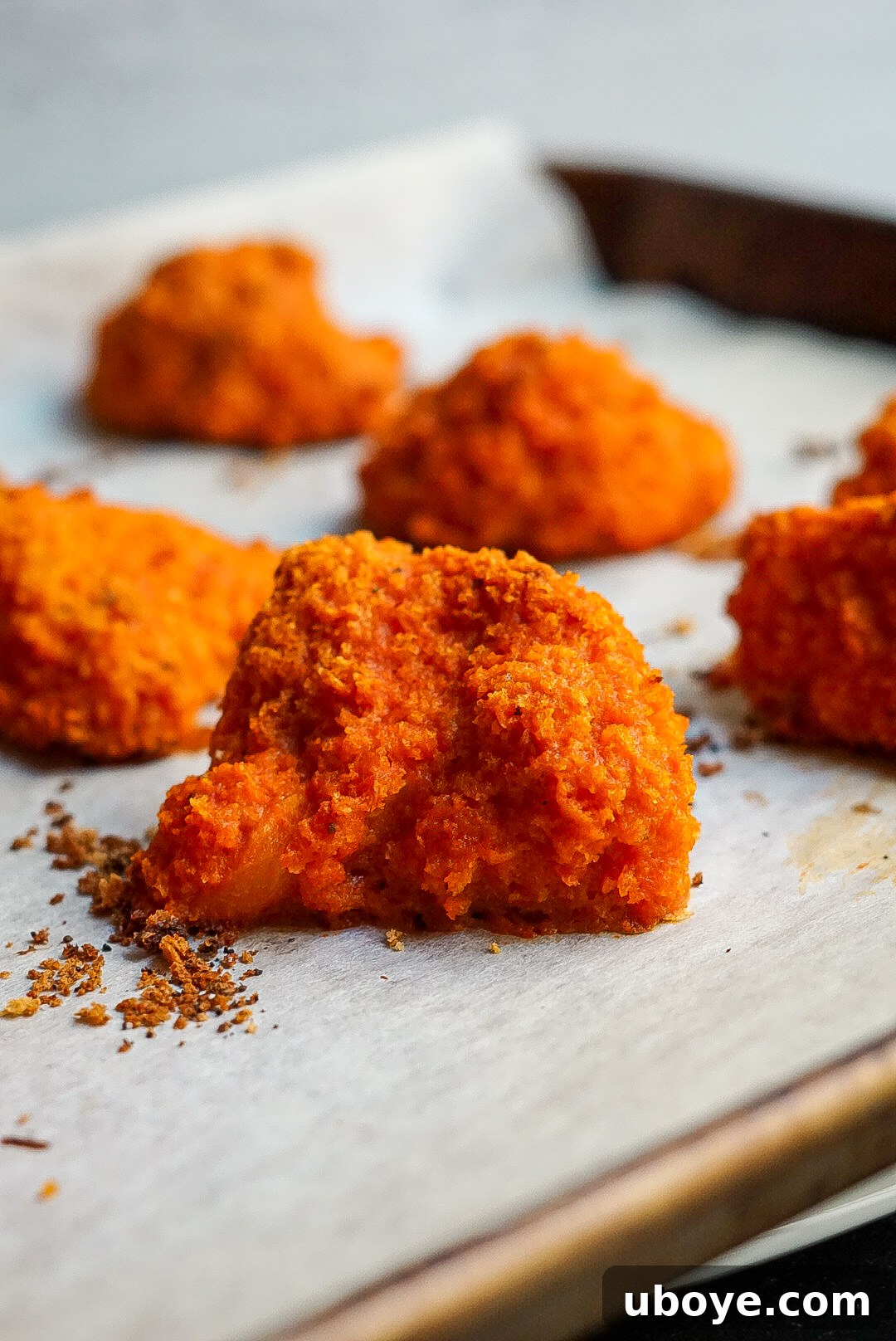 Hand dipping a vegan buffalo cauliflower wing into creamy ranch dressing