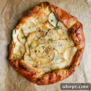 Finished Potato Tart with Garlic Confit & Sour Cream Puff Pastry, golden and inviting.