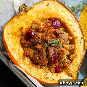 Beautifully plated maple roasted acorn squash with vegan cornbread sausage stuffing.