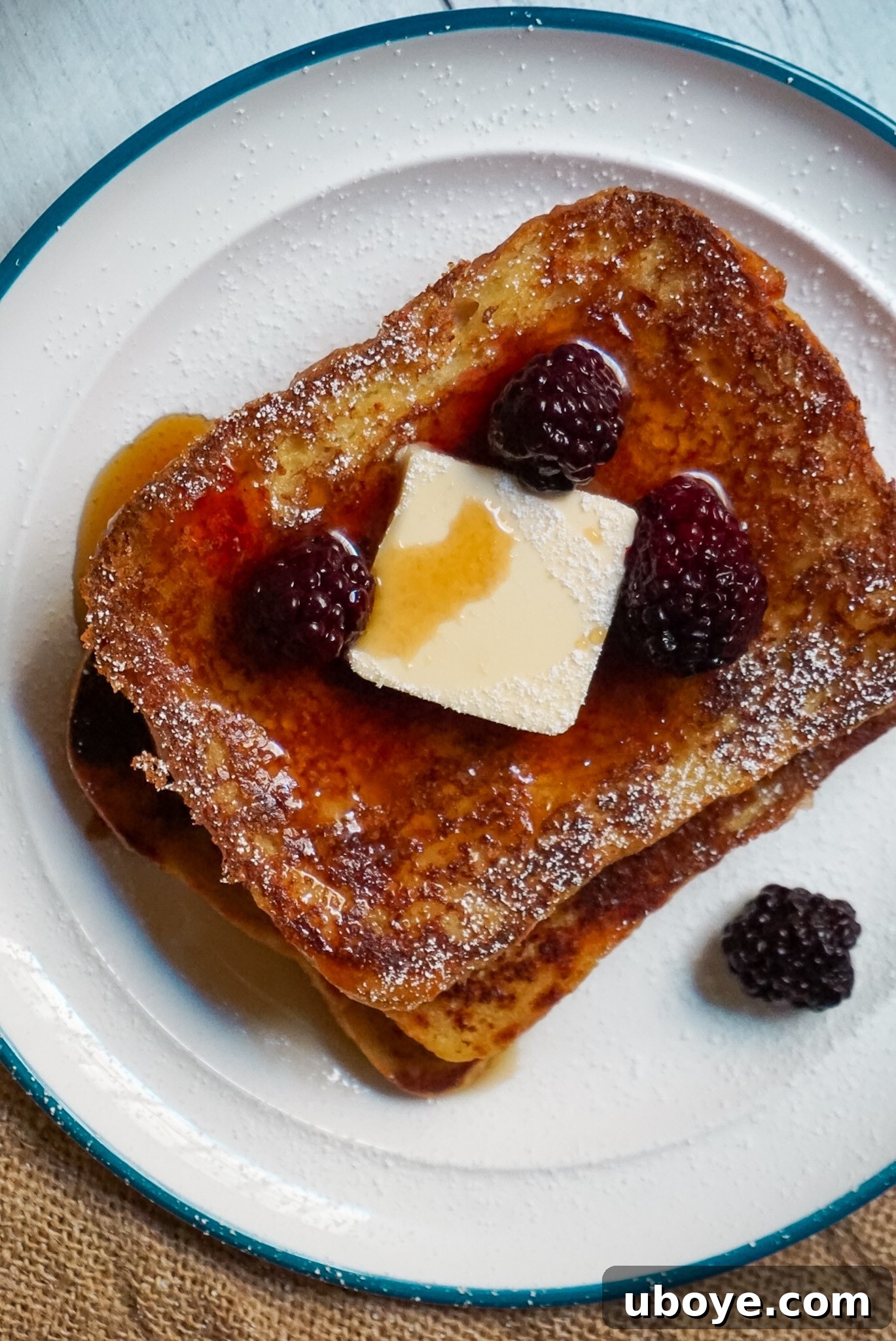 Delicious Vegan French Toast for one, drizzled with maple syrup and topped with fresh berries, ready to eat.