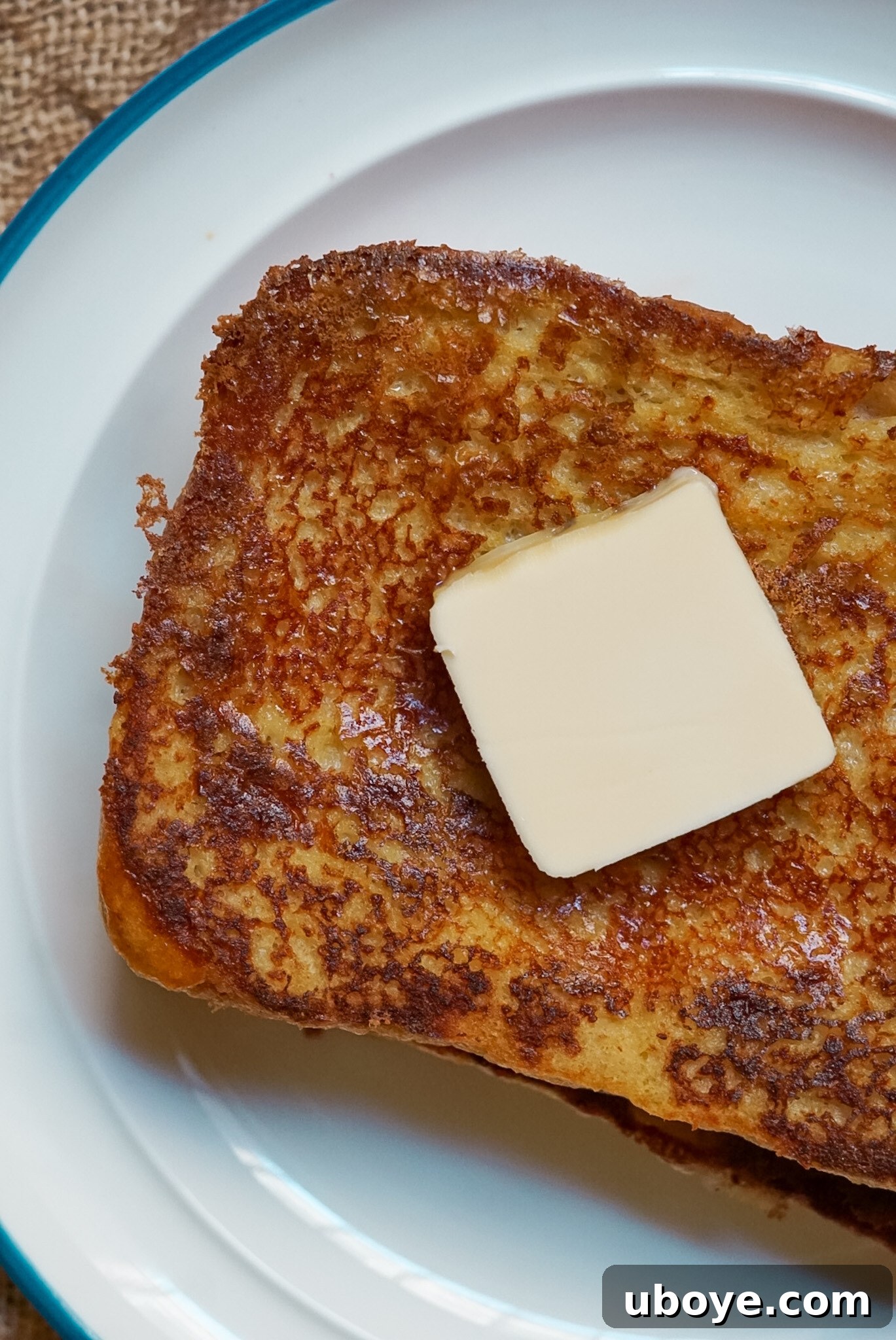 Close-up of golden brown vegan French Toast, showing the crispy edges and soft texture.