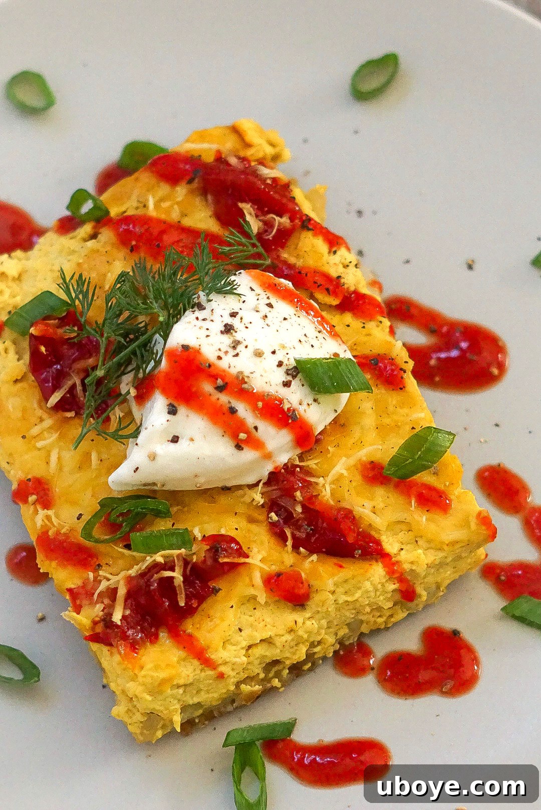 Close-up of the vegan breakfast casserole, showcasing the creamy filling and crispy topping