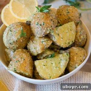 potato salad with lemons and herbs in a white bowl