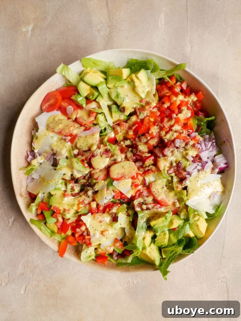 Crispy Crumbed Chicken salad in a large bowl with dressing all over