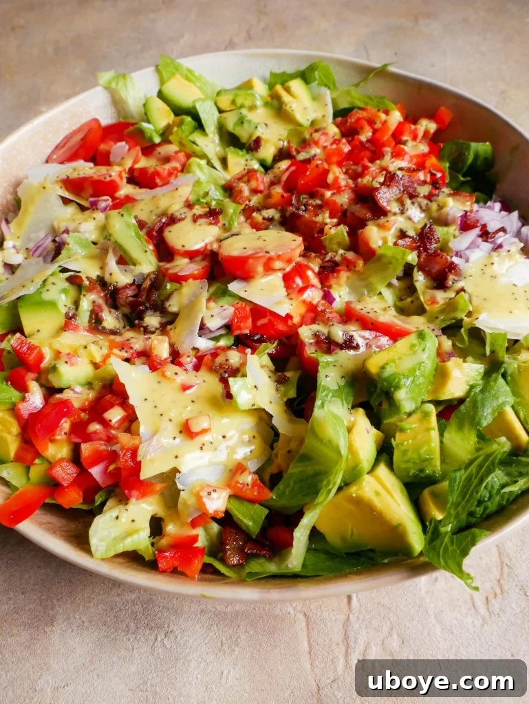 Crispy Crumbed Chicken salad in a large bowl with dressing all over