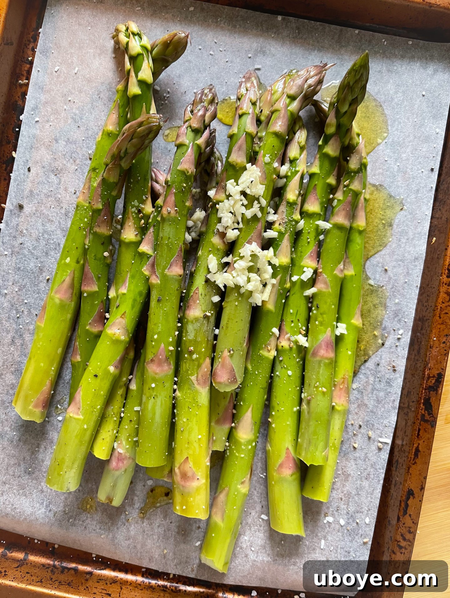 adding garlic to the asparagus