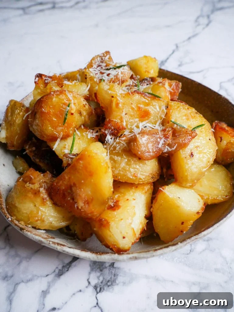 Close-up of a bowl filled with garlic confit crispy roasted potatoes, ready to be enjoyed
