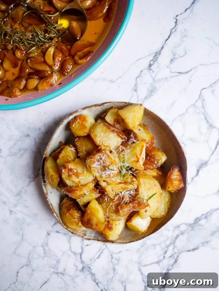 Individual garlic confit crispy roasted potatoes plated, showing crisp texture and seasonings
