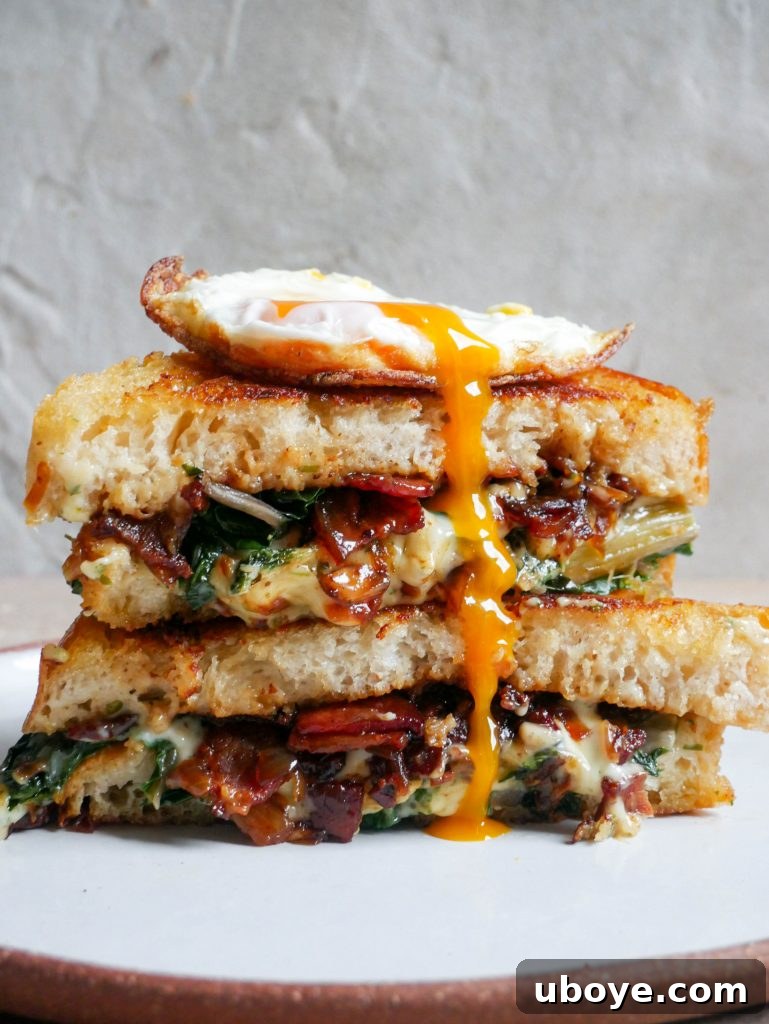 Breakfast toastie with a perfectly fried egg on top, showcasing the golden bread and rich filling