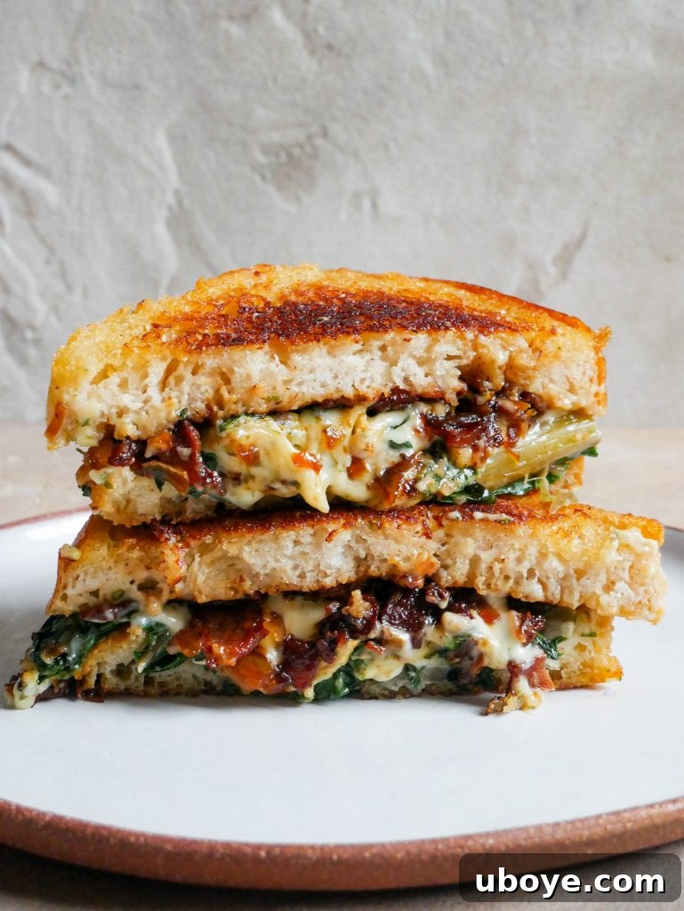 Close-up of a breakfast toastie with bacon jam visible, highlighting the gooey cheese and toasted bread