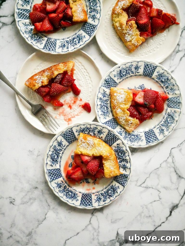 Strawberry, port and lemon galette sliced onto small plates, ready to serve