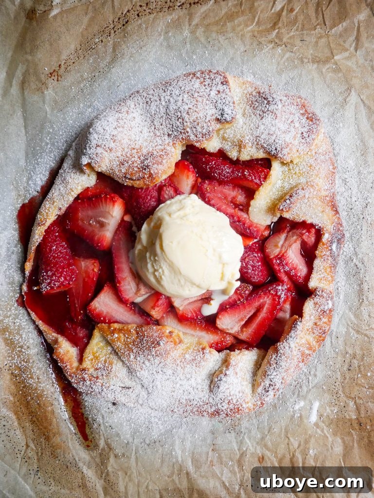 Close-up of a rustic strawberry galette, showcasing its golden crust and juicy filling