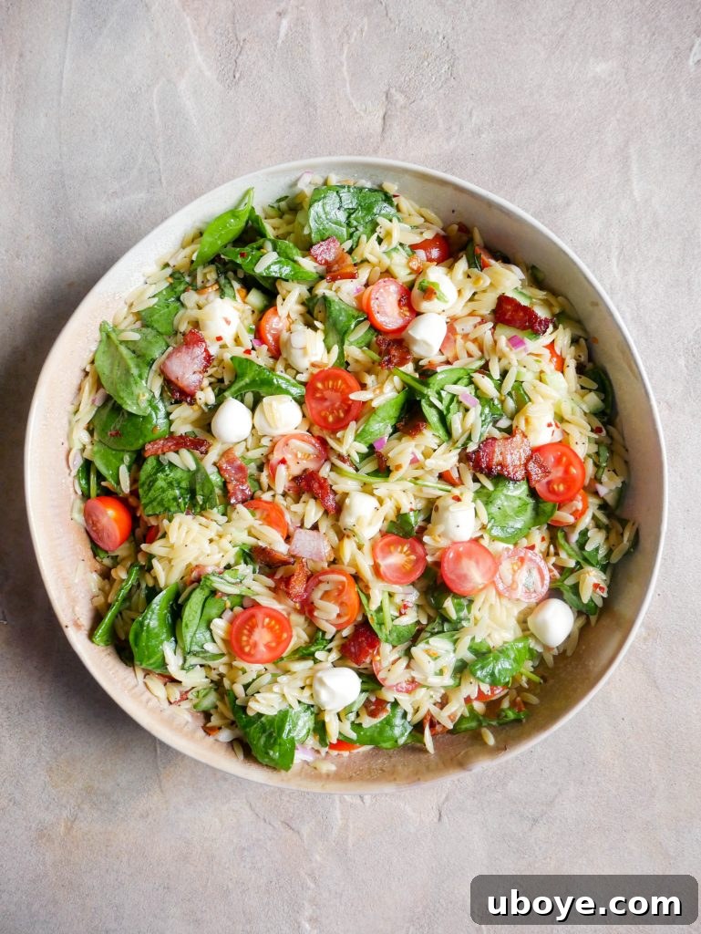 Vibrant Basil Garlic Pesto Summer Pasta Salad in a large bowl
