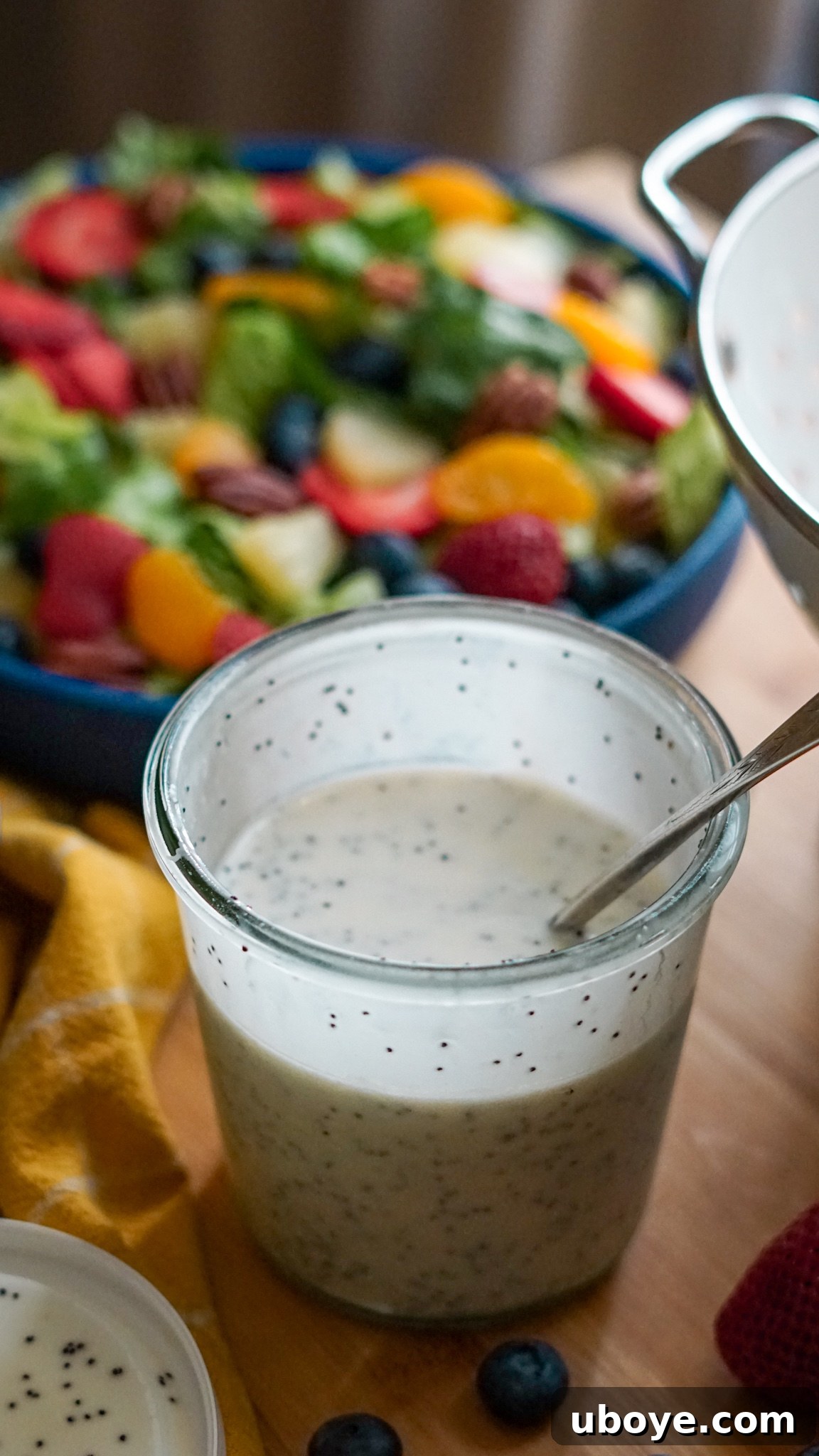Close-up of fresh ingredients for Panera copycat salad, including strawberries, blueberries, and romaine