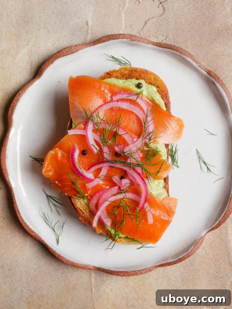 Avocado smash on toast with quick pickled onions, ready to be topped with a poached egg.
