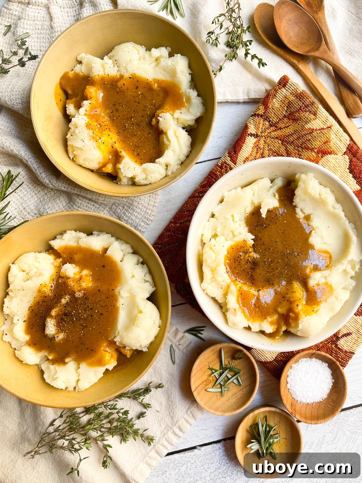 Vegan gravy generously drizzled over fluffy mashed potatoes, garnished for a festive holiday meal