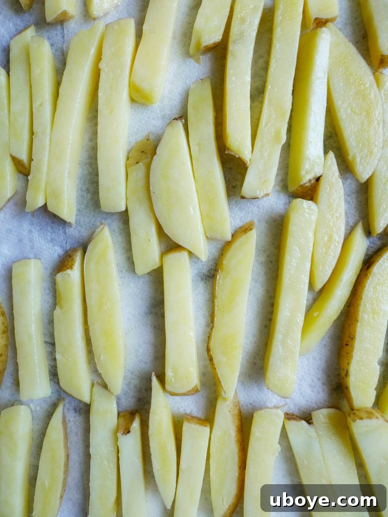 Close-up of perfectly cut and cooked triple-cooked chips, showcasing their golden-brown exterior.