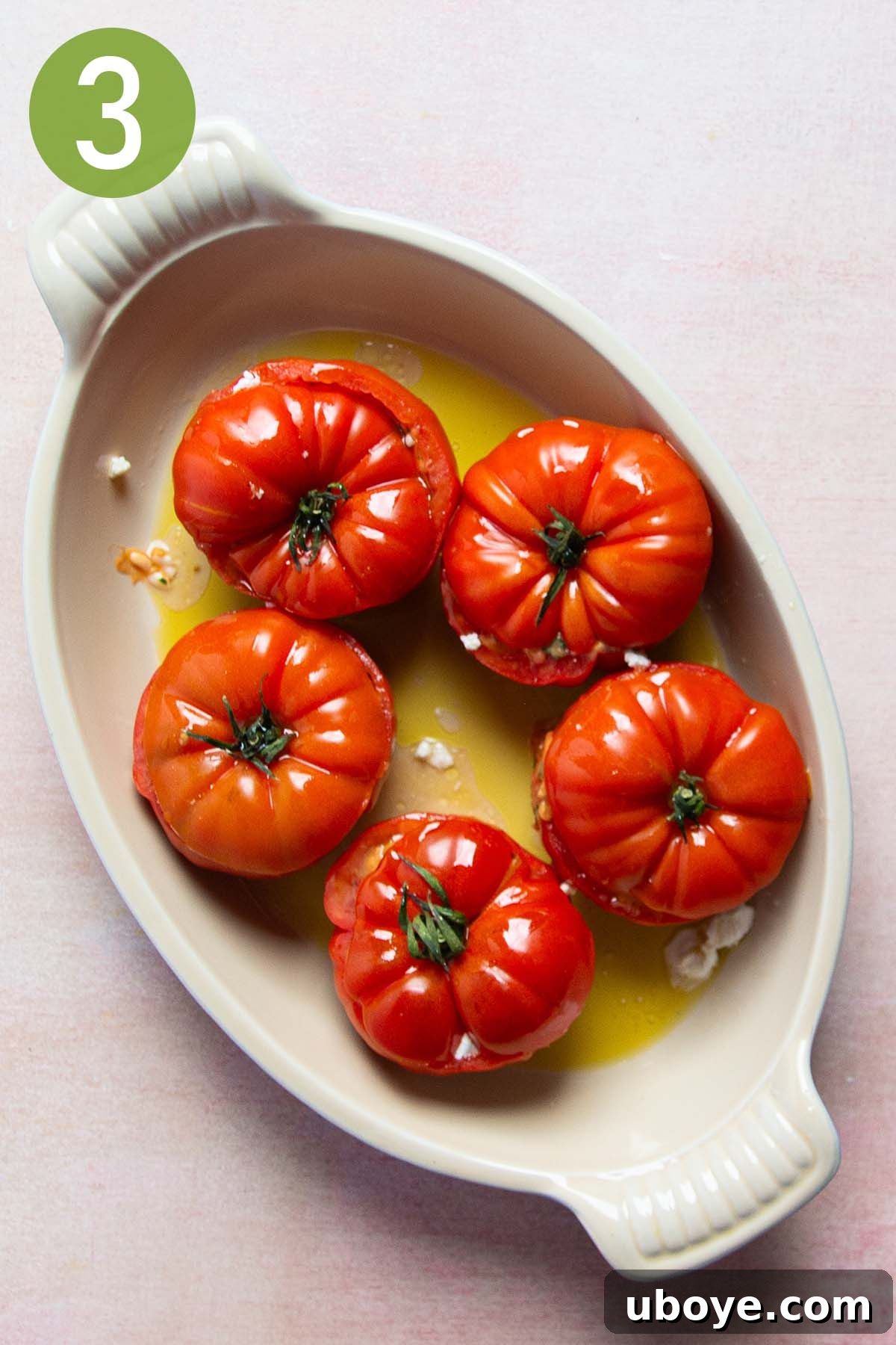 Mediterranean Tomato Treasures 6 Hollowed tomatoes stuffed with rice filling, topped with crumbled goat cheese, and drizzled with olive oil, ready to be covered and baked.