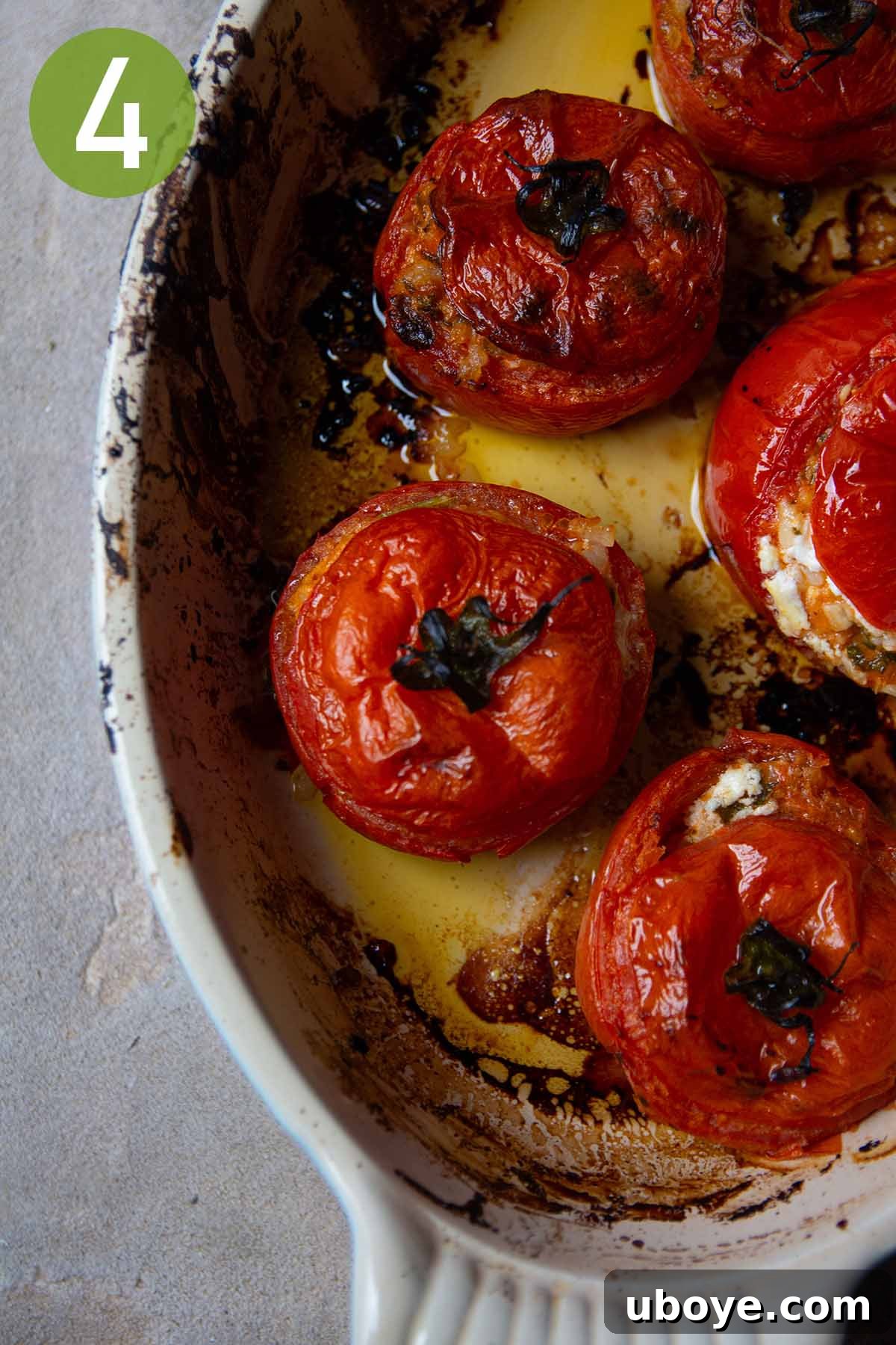 Mediterranean Tomato Treasures 7 Golden-brown baked stuffed tomatoes presented in an oval ceramic baking dish, bubbling hot from the oven.
