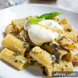 plate of garlic confit pesto pasta with garnish.