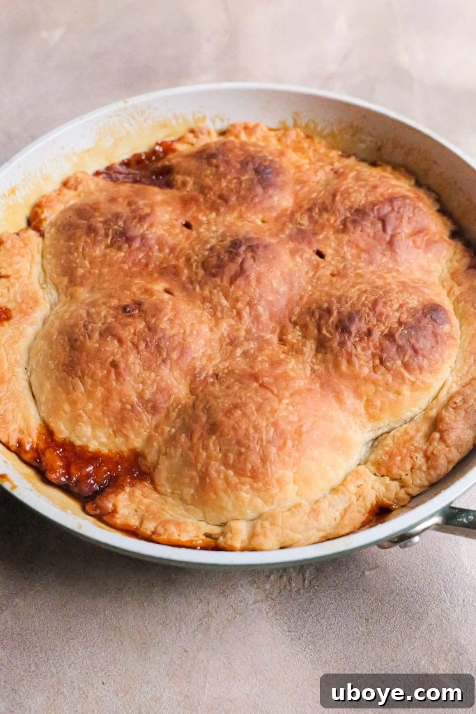 Layered caramelized apples under pastry crust of Tarte Tatin