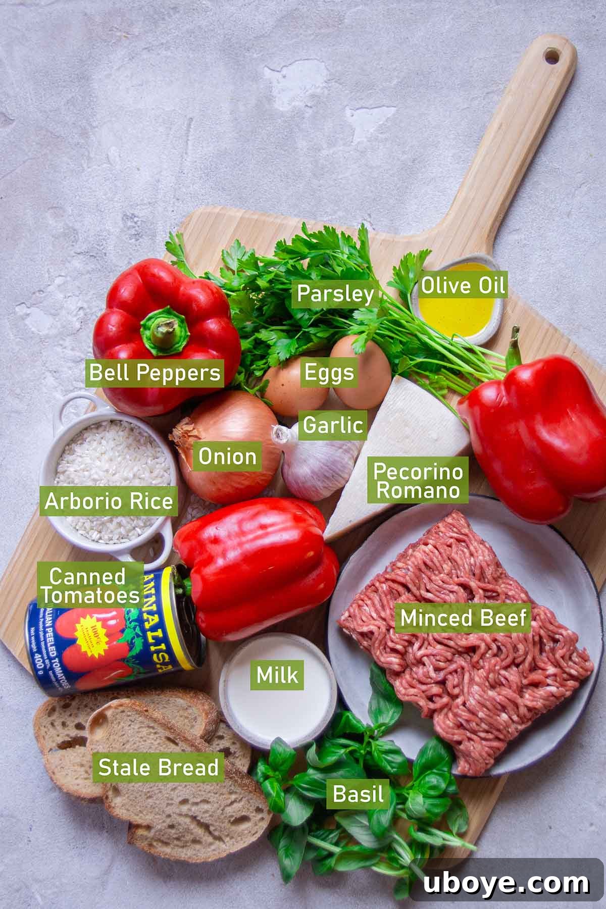 Hearty Beef and Rice Stuffed Peppers 3 Ingredients for beef and rice stuffed bell peppers laid out on a table.