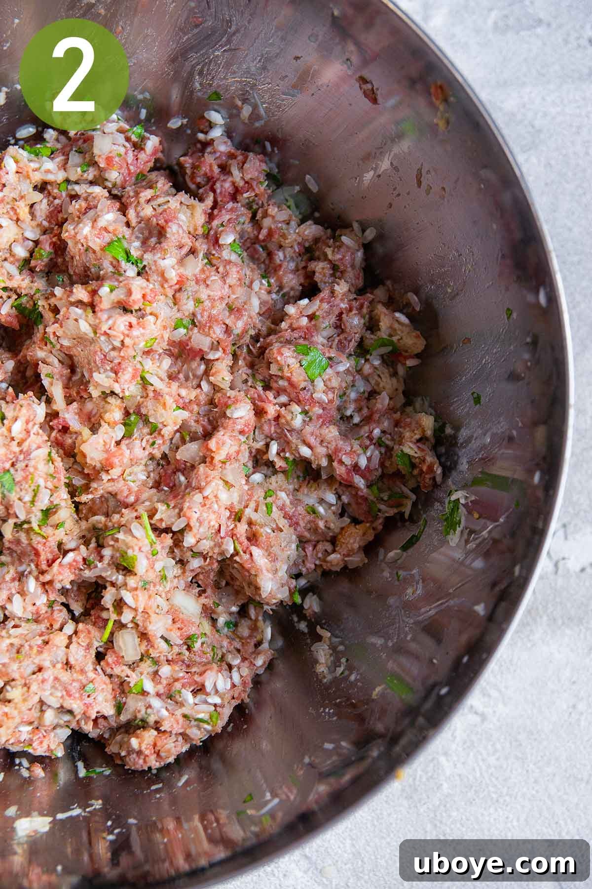 Hearty Beef and Rice Stuffed Peppers 5 Mixing ground beef, rice, and herbs in a large bowl for the stuffing.