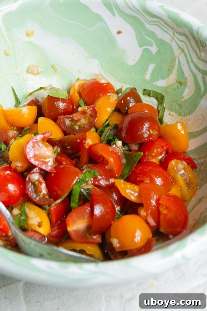 Fire-Kissed Vegetable Bruschetta 6 A bowl of vibrant bruschetta topping with cherry tomatoes, basil, and shallots