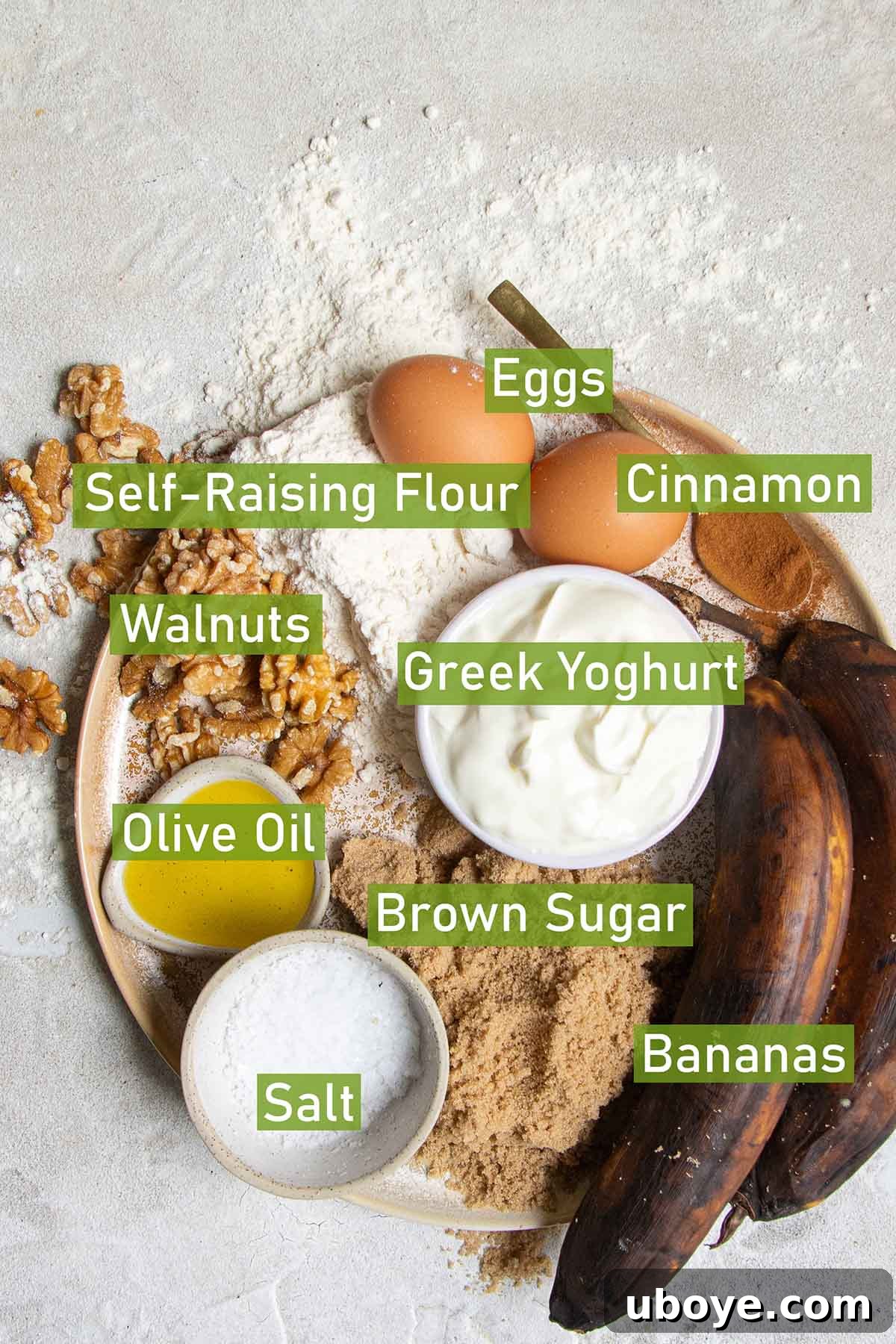 Bowls of fresh ingredients for baking olive oil banana bread, including ripe bananas, eggs, flour, and a bottle of olive oil.