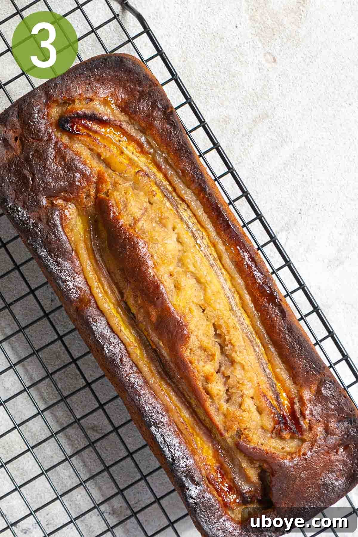 A freshly baked loaf of olive oil banana bread cooling on a wire rack, filling the kitchen with its irresistible aroma.