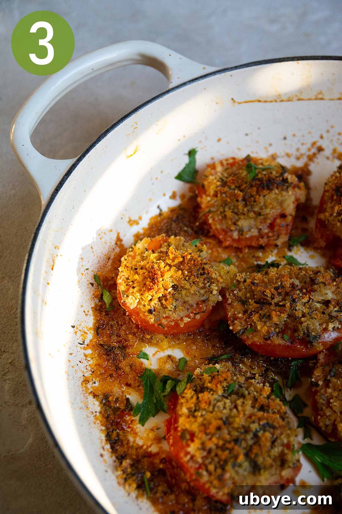 Sun-Kissed Roasted Tomatoes with Garlic-Herb Crumble 6 baked stuffed tomatoes in a cast iron pot.